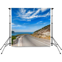 Turn Of Mountain Highway With Dramatic Blue Sky And Sea Backdrops 57698760