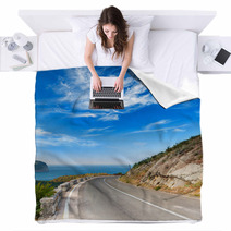 Turn Of Mountain Highway With Dramatic Blue Sky And Sea Blankets 57698760