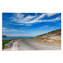 Turn Of Mountain Highway With Dramatic Blue Sky And Sea Rugs 57698760