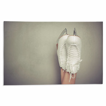 Woman Wearing Ice Skates Against A Wall Rugs 63710297