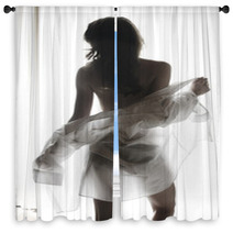 Young Woman Undressing Window Curtains 56946346