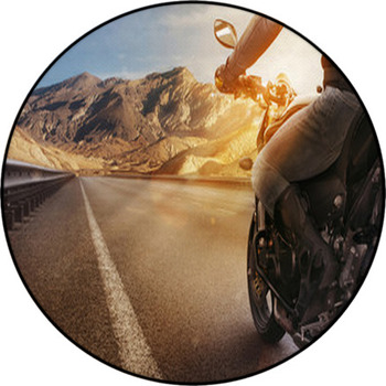 Biker Riding Motorcycle On An Empty Road At Round Rug