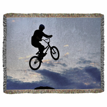 BMX Rider Making A Bike Jump Woven Throw Blanket