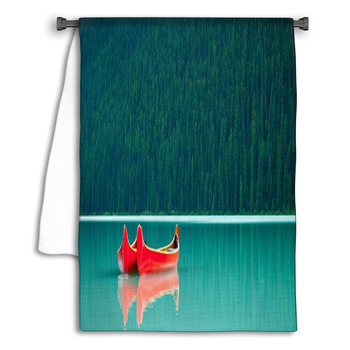 Canoes Floating Peacufully On Lake Louise Near Towel