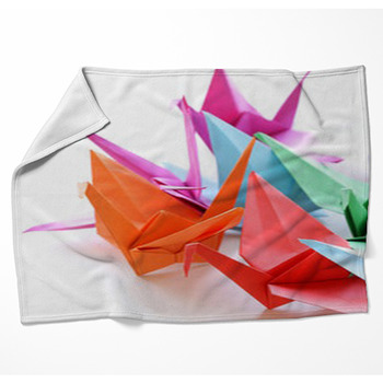 Colorful Paper Origami Birds On A Woven Throw Blanket