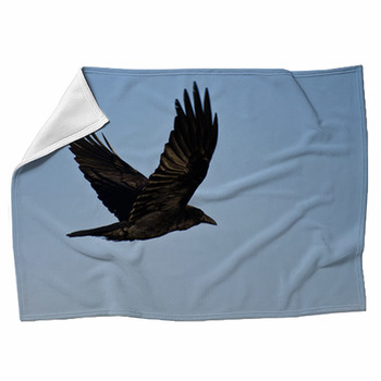 Common Raven Flying In A Blue Sky Fleece Blanket