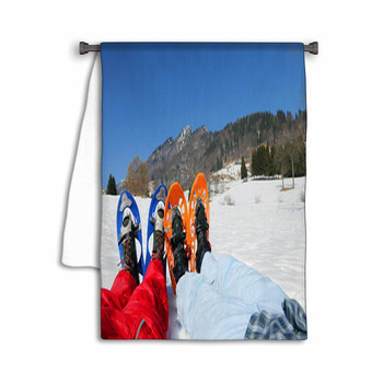 Couple With Blue And Orange Snowshoes In The Towel