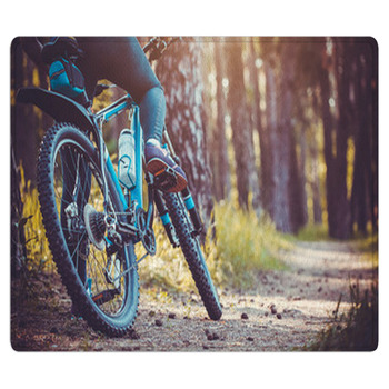 Cyclist Riding Mountain Bike In The Forest Area Rug