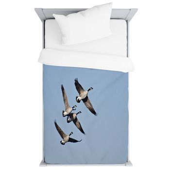 Four Canada Geese Flying In Blue Sky Toddler Duvet