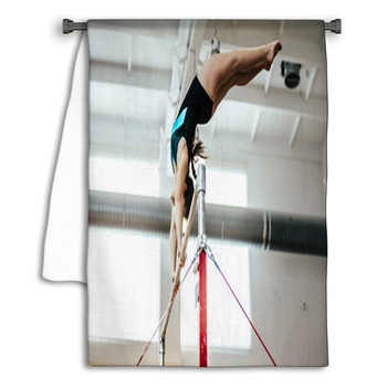 Girl Athlete Gymnast Exercises On Uneven Bars Towel