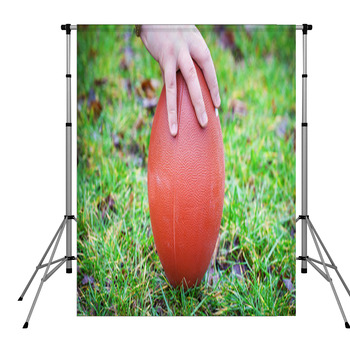 Hand On Rugby Ball On Green Grass Pole Pocket Backdrop
