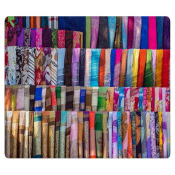 Various Of Colorful Fabrics And Shawls At A Bath Mat